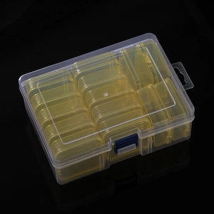 Detail view of 14 removable inner containers inside a clear plastic organizer box