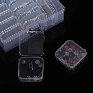Close-up of clear 14-grid plastic storage box with removable compartments for DIY beads