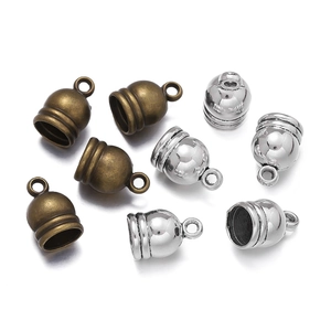 Macro view of bell-shaped zinc alloy cord end caps with vintage tassels and crown design