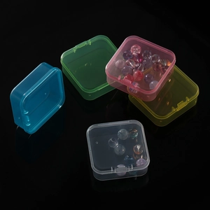 Five small colorful transparent plastic storage boxes with lids for beads and components