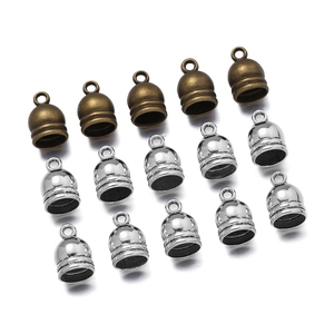 Detail of vintage zinc alloy bell tassels and cord end caps with hanging loops for DIY jewelry