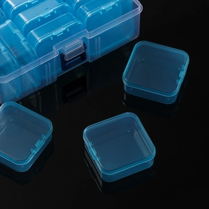 Detail view of transparent blue 14-grid plastic organizer box for beads and small parts