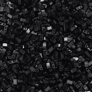 Close-up of glossy black double-hole Tila beads for DIY jewelry weaving and crafts