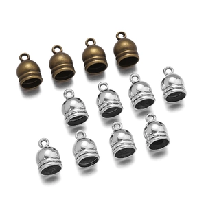 Detailed view of antique silver and bronze cord end caps for jewelry tassels and necklaces