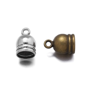 Detailed macro view of bell-shaped zinc alloy cord end caps in silver and bronze finishes