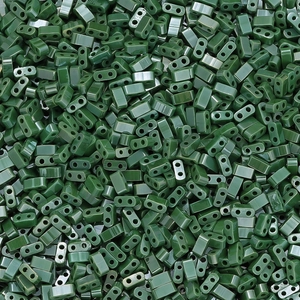 Macro shot of dark green rectangular glass beads with double holes for DIY jewelry