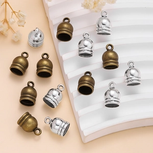 Silver and bronze bell-shaped cord end caps with decorative grooves for DIY jewelry making
