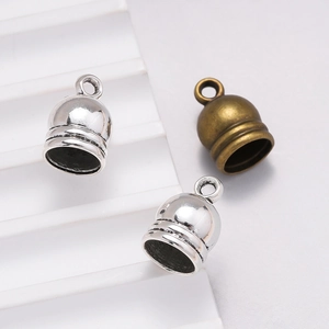 Macro shot of zinc alloy tassel caps in antique silver and bronze for DIY jewelry making