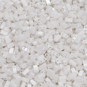 Macro shot of pearl white glass beads with two parallel holes for DIY jewelry making