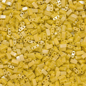 Macro detail of bright yellow rectangular dual-hole glass beads for DIY jewelry making