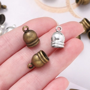 Detail of vintage zinc alloy tassel end caps in bronze and silver for DIY jewelry