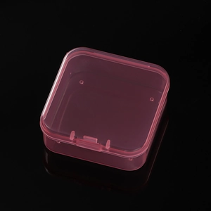 Close-up of pink translucent 14-grid plastic organizer box with individual lids
