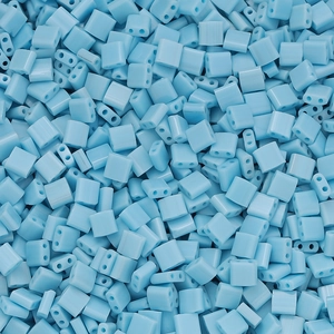 Close-up of light blue glass square beads with double holes for DIY jewelry making