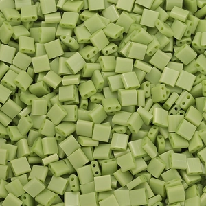 Macro shot of light green rectangular two-hole glass spacer beads for DIY jewelry making