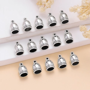 Close-up of silver zinc alloy tassel end caps and crown bead caps for DIY jewelry making