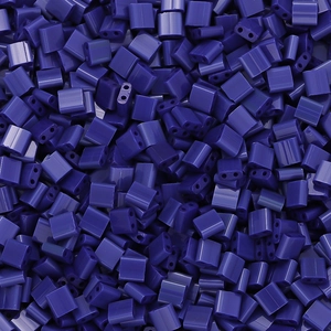 Macro shot of dark purple square two-hole glass tila beads for DIY jewelry making