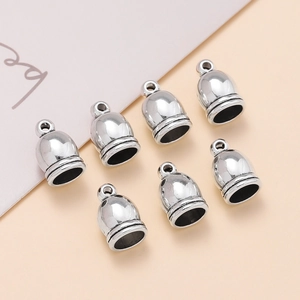 Detailed macro of vintage silver zinc alloy tassel caps for DIY jewelry making