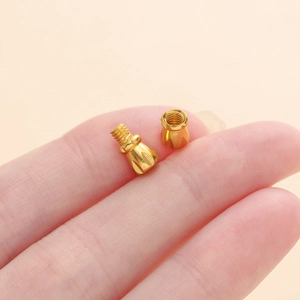 Micro golden screw clasps for DIY jewelry necklaces shown on a fingertip for scale