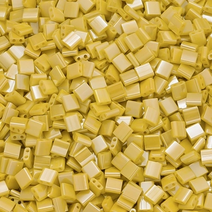 Macro shot of bright yellow rectangular dual-hole glass beads for DIY jewelry making