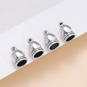 Close-up of vintage silver zinc alloy bell-shaped tassel end caps for DIY jewelry making