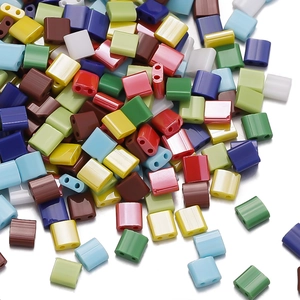 Macro shot of colorful two-hole square glass Tila beads for handmade DIY jewelry crafting