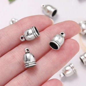 Silver alloy bell-shaped cord ends with decorative lines and top hanging loops