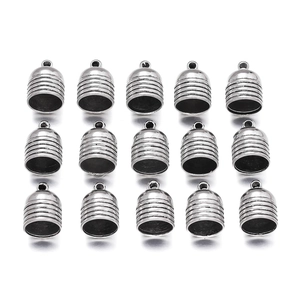 Detailed close-up of zinc alloy end caps with textured stripes for DIY jewelry making