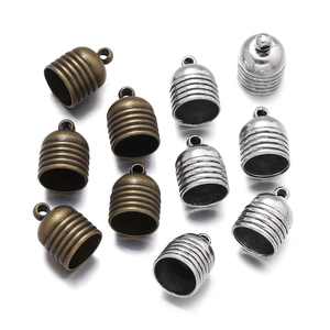 Macro shot of zinc alloy tassel end caps in vintage bronze and silver finishes for DIY