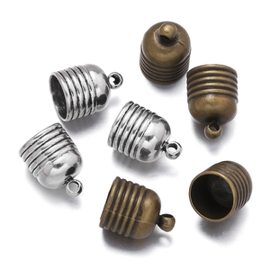 Detail of zinc alloy tassel end caps in silver and bronze for jewelry making