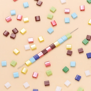 Detailed view of colorful two-hole glass Tila beads for DIY jewelry making and weaving