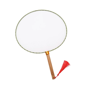 Detail of a white silk round fan with bamboo handle, green border, and red silk tassel