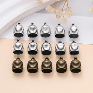 Detail of ribbed bell-shaped cord end caps in bright silver and antique bronze finish