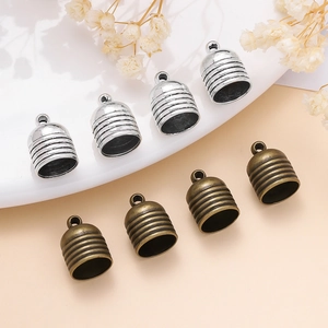 Detail of vintage zinc alloy tassel end caps in silver and bronze for DIY jewelry