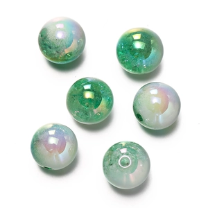 Detail of 16mm emerald green acrylic snowflake beads with iridescent UV coating for DIY crafts