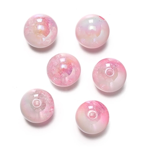 Macro detail of 16mm pink UV coated snowflake gradient acrylic beads with internal textures