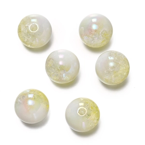 Macro shot of 16mm iridescent cream acrylic beads with gold foil for DIY jewelry making