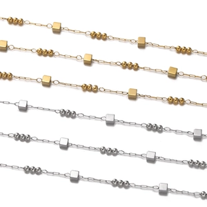 Detail of gold and silver stainless steel chain with cube beads for jewelry making
