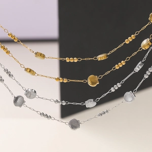 Macro detail of gold and silver stainless steel shell charm chains for jewelry making