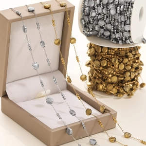 Close-up of gold and silver shell-shaped DIY jewelry chains with round metal beads