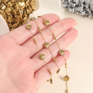 Detailed view of handmade stainless steel gold plated shell and bead chain for DIY jewelry