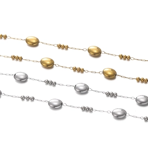 Detail of gold and silver oval bead chains with polished minimalist stainless steel link