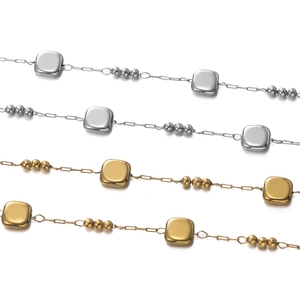Detailed macro view of gold and silver stainless steel square bead jewelry chains
