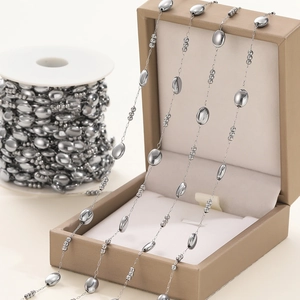 Macro view of stainless steel oval bead and link chain for jewelry making and DIY crafts