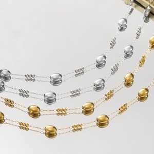 Polished stainless steel oval bead and link chain detail in gold and silver finish