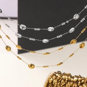 Macro shot of oval gold and silver steel beads chain for DIY jewelry necklace making