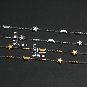 Macro detail of star and moon charms on stainless steel chains with measurements