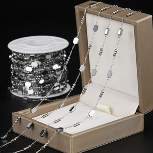 Close-up of stainless steel bead and geometric plate link chain for DIY jewelry