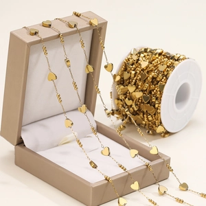 Detail view of golden stainless steel heart chain on a jewelry box for DIY crafts