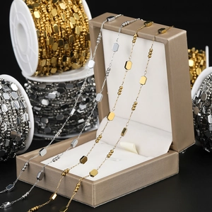 Macro detail of gold and silver square link chains for DIY jewelry making accessories