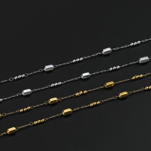 Detail of stainless steel cylinder and bead chain links in gold and silver finish